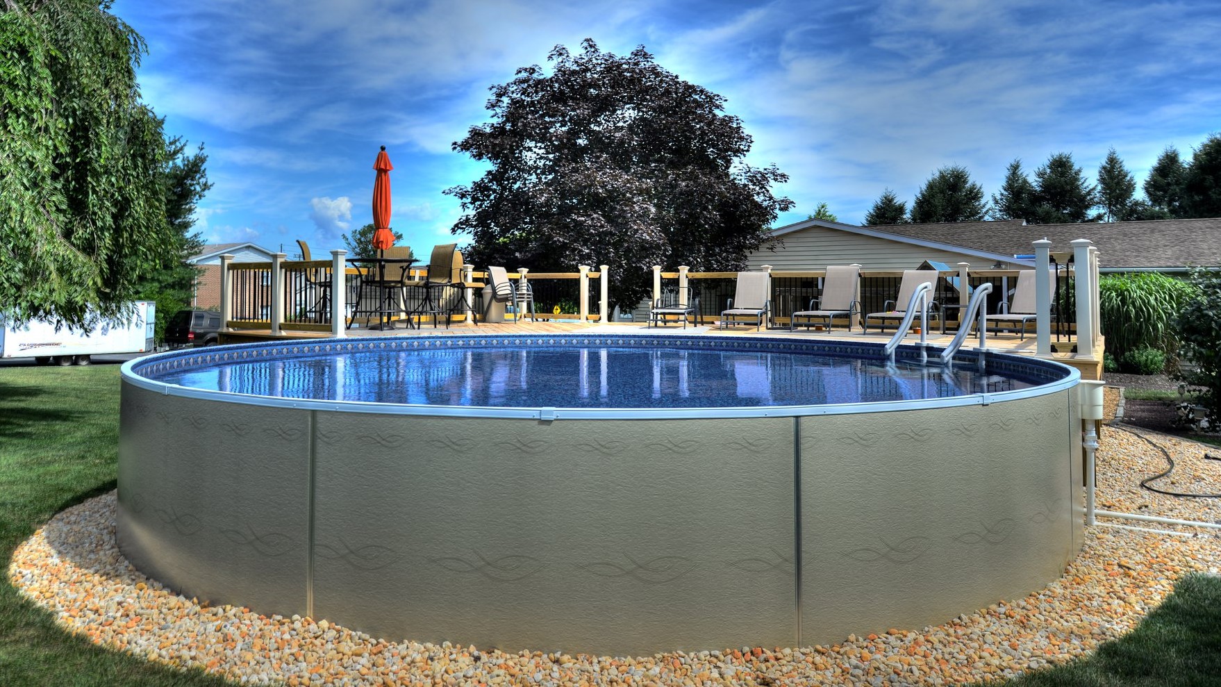 Round Radiant Metric Series pool installed in a landscaped backyard